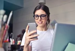Woman on phone and laptop